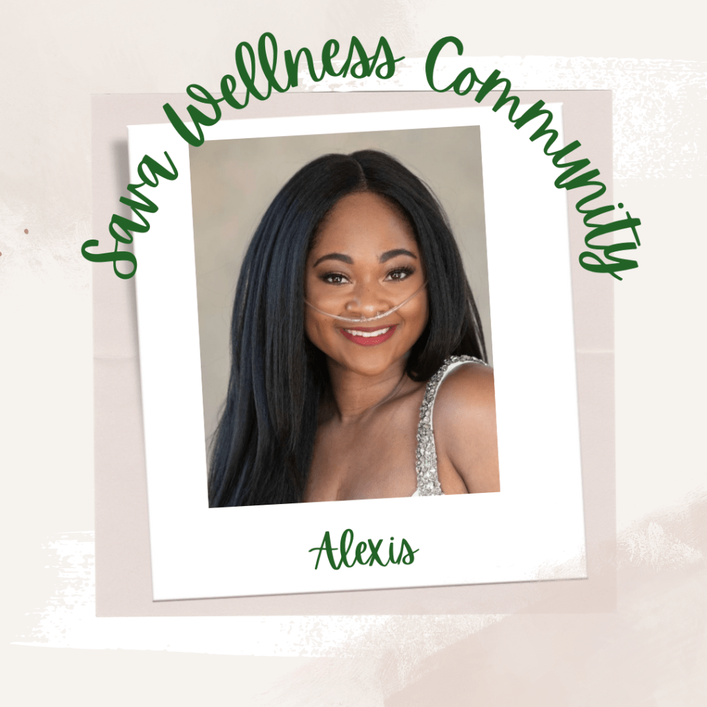 The words “Sava Wellness Community” are written in green cursive script over top of a polaroid picture. The polaroid picture is sitting on top of multiple layers of pink, cream, and white watercolour background. The polaroid picture has the name “Alexis” written in green under it. The picture is of Alexis smiling at the camera with her hair down. Alexis is wearing a nasal cannula and a white dress with sparkly shoulder straps.