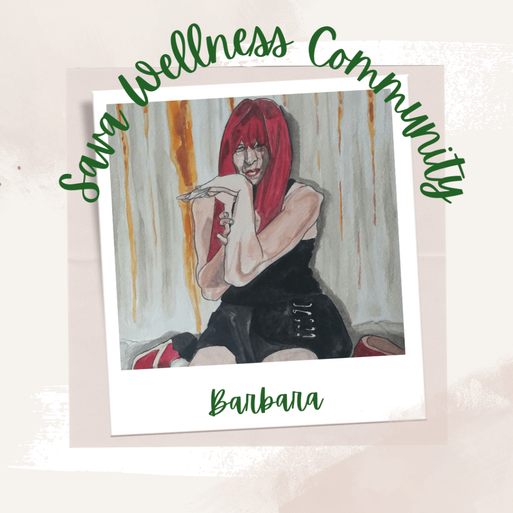 The words “Sava Wellness Community” are written in green cursive script over top of a polaroid picture. The polaroid picture is sitting on top of multiple layers of pink, cream, and white watercolour background. The polaroid picture has the name “Barbara” written in green under it. This is an artist representation of Barbara’s hypermobility that Barbara created herself. The subject is Barbara who has long red hair. She is holding her left arm which has her wrist extended. Barbara is sitting on the floor with her red shoes near her hips and she is wearing black.]